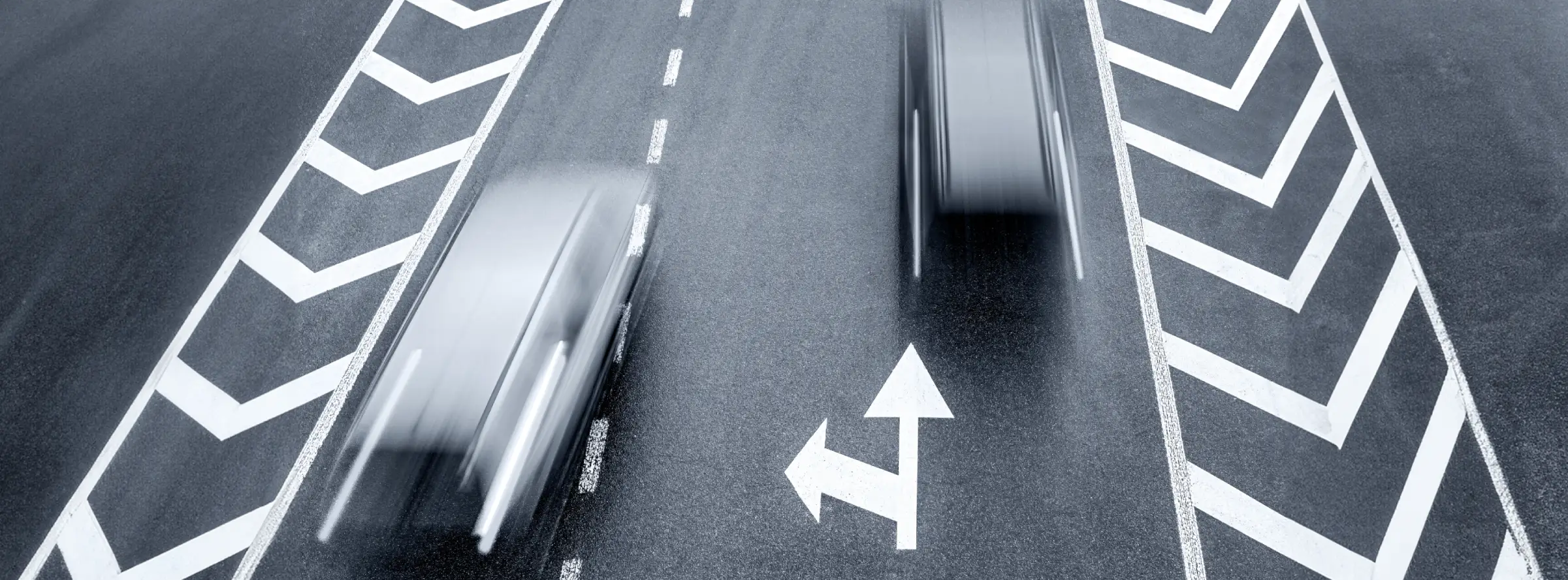 Cars moving quickly on a two-lane road
