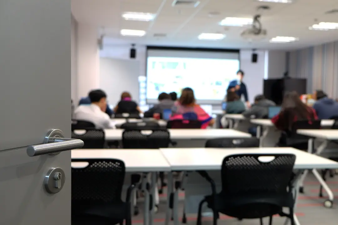 Students in a classroom in front of a projector